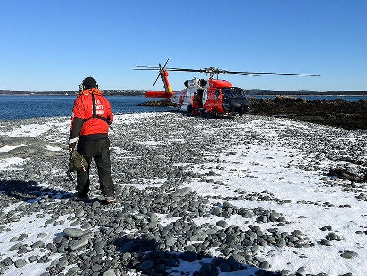 Chase Miller walking back to the MH-60T Jayhawk helicopter on deck at Egg Rock Light.