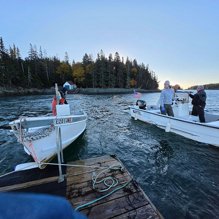 Skiffs moving the Little River Island floats